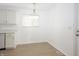 Bright eat-in kitchen with laminate floors and all-white accents with updated lighting at 412 S Norfolk St, Indianapolis, IN 46241