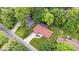 Aerial view reveals a red-roofed house amidst green trees, with a neatly kept lawn and a long driveway at 434 Verwood Ct, Indianapolis, IN 46234