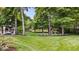 A well-manicured backyard with green lawn and mature trees provides a serene setting for relaxation and outdoor activities at 434 Verwood Ct, Indianapolis, IN 46234