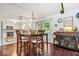 Open-concept dining area connected to the kitchen, features a modern light fixture and an outdoor view at 434 Verwood Ct, Indianapolis, IN 46234