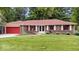 Charming brick ranch home with a well-manicured lawn and a welcoming red front door at 434 Verwood Ct, Indianapolis, IN 46234
