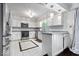 Modern kitchen with stainless steel appliances, white cabinets, and stylish lighting fixtures at 434 Verwood Ct, Indianapolis, IN 46234