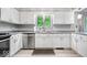 Bright kitchen featuring stainless steel appliances, white cabinets, and a view of the outdoors at 434 Verwood Ct, Indianapolis, IN 46234