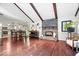 Inviting living room area with a stone fireplace and wooden beams, next to a dining area and a kitchen at 434 Verwood Ct, Indianapolis, IN 46234
