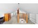 Finished attic space with exposed brick detail and open railing, offering versatile potential at 4414 Winthrop Ave, Indianapolis, IN 46205