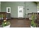 Cozy back porch with wood railing and potted flowers; perfect for outdoor relaxation at 4414 Winthrop Ave, Indianapolis, IN 46205