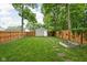 Spacious backyard with wood fence, garden, and shed; ideal for outdoor activities at 4414 Winthrop Ave, Indianapolis, IN 46205
