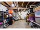 Unfinished basement with wood beams, shelving, and concrete floors; ready for renovation at 4414 Winthrop Ave, Indianapolis, IN 46205