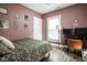 A quaint bedroom featuring hardwood floors and natural light from the large window, creating a peaceful atmosphere at 4414 Winthrop Ave, Indianapolis, IN 46205