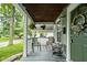View of a cozy front porch with seating and charming decorative details at 4414 Winthrop Ave, Indianapolis, IN 46205