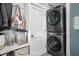 A well-equipped laundry area features a stacked washer and dryer, along with ample storage and shelving at 4414 Winthrop Ave, Indianapolis, IN 46205