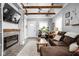 Stylish living room with modern fireplace, exposed beams and neutral decor at 4414 Winthrop Ave, Indianapolis, IN 46205
