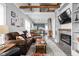 Open concept living space with fireplace, ladder access to loft and view of the kitchen at 4414 Winthrop Ave, Indianapolis, IN 46205