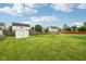 Expansive backyard with a shed, trampoline, and play area, perfect for outdoor activities and Gathering fun at 4434 W Windsong Ct, New Palestine, IN 46163
