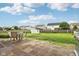 Large backyard with patio, seating, grill, and play area, ideal for relaxing and entertaining at 4434 W Windsong Ct, New Palestine, IN 46163