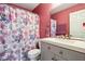 Bathroom with a flower-patterned shower curtain, vanity, and a modern sink at 4434 W Windsong Ct, New Palestine, IN 46163