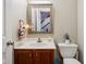 Cozy bathroom features sink, vanity, mirror and adjacent toilet at 4434 W Windsong Ct, New Palestine, IN 46163