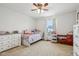 Bedroom with carpet, window, dresser, ceiling fan, and a twin sized bed at 4434 W Windsong Ct, New Palestine, IN 46163