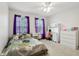 Bedroom with light carpet, purple curtains, and a full sized bed at 4434 W Windsong Ct, New Palestine, IN 46163