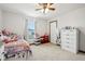 Bedroom with carpet, a twin sized bed, window, and a white dresser with mirror at 4434 W Windsong Ct, New Palestine, IN 46163