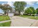 Spacious driveway leading to a charming home with a well-manicured lawn at 4434 W Windsong Ct, New Palestine, IN 46163