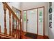 Bright foyer featuring a white front door with sidelights, and wood trim at 4434 W Windsong Ct, New Palestine, IN 46163