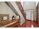 Stylish foyer with decorative shelving, wooden trim, and hardwood floors at 4434 W Windsong Ct, New Palestine, IN 46163