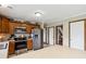 Well-lit kitchen features wood cabinets, stainless steel appliances, and a long island at 4434 W Windsong Ct, New Palestine, IN 46163