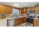 Well-lit kitchen features wood cabinets, stainless steel appliances, and mosaic backsplash at 4434 W Windsong Ct, New Palestine, IN 46163