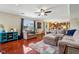 Open-concept living room with hardwood floors, comfortable seating, and natural light at 4434 W Windsong Ct, New Palestine, IN 46163
