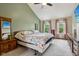 Primary bedroom with a vaulted ceiling, wall-mounted TV, and scenic outdoor views at 4434 W Windsong Ct, New Palestine, IN 46163
