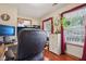 Office space with a view features built in cabinet, desk and red curtains at 4434 W Windsong Ct, New Palestine, IN 46163