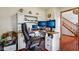 Bright office space with built-in desk, rolling chair, and hardwood floors at 4434 W Windsong Ct, New Palestine, IN 46163