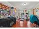 Spacious room featuring hardwood floors, shelves, and workout equipment including a treadmill at 4434 W Windsong Ct, New Palestine, IN 46163