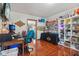 Large room with tables, shelves, decor, hardwood floor and open doorway at 4434 W Windsong Ct, New Palestine, IN 46163