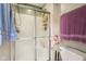 Bathroom with a shower featuring sliding glass doors and a white toilet, with toiletries and towels at 4434 W Windsong Ct, New Palestine, IN 46163