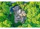 Beautiful aerial view of a property with a paved driveway, patio set, and a roof in a lush, tree-filled landscape at 4530 Chase Oak Ct, Zionsville, IN 46077