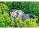 Aerial view of a stunning home surrounded by lush greenery and mature trees at 4530 Chase Oak Ct, Zionsville, IN 46077