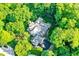 Overhead view of a home and driveway surrounded by vibrant trees at 4530 Chase Oak Ct, Zionsville, IN 46077