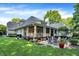 Spacious, lush backyard featuring a covered porch and a patio with a fire pit at 4530 Chase Oak Ct, Zionsville, IN 46077
