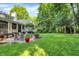 A lush backyard features a patio and a cozy seating area with chairs at 4530 Chase Oak Ct, Zionsville, IN 46077