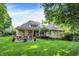 Lush backyard features covered porch and patio with cozy seating at 4530 Chase Oak Ct, Zionsville, IN 46077