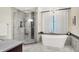 Modern bathroom features a soaking tub, glass shower, and elegant tile work at 4530 Chase Oak Ct, Zionsville, IN 46077