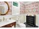 Charming half bath with floral wallpaper, gold mirror, and elegant vanity at 4530 Chase Oak Ct, Zionsville, IN 46077
