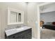Bathroom with a stylish vanity featuring a marble countertop and decorative mirror at 4530 Chase Oak Ct, Zionsville, IN 46077