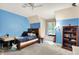 Bright bedroom with blue accent wall, a window bench, and a bookshelf at 4530 Chase Oak Ct, Zionsville, IN 46077