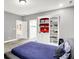 Bedroom with a built-in bookcase with red accents at 4530 Chase Oak Ct, Zionsville, IN 46077