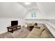 Cozy bonus room with vaulted ceiling, lounge seating, and built-in shelving at 4530 Chase Oak Ct, Zionsville, IN 46077