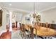 Formal dining room with a large wooden table, chandelier, and views to the exterior at 4530 Chase Oak Ct, Zionsville, IN 46077