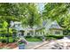Beautiful home with a well-manicured lawn, mature trees, and a cozy covered porch with American flag at 4530 Chase Oak Ct, Zionsville, IN 46077